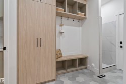 Built-in storage solutions featuring wood-finish cabinetry and open shelving - 