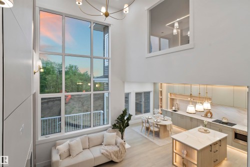 Two-story living area featuring a prominent full-height window, a coffered ceiling, and wood-finish flooring - 3305 Chickadee Drive, Edmonton, AB 