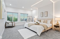 Spacious bedroom featuring plush gray carpeting and expansive windows - 