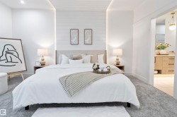 Bedroom featuring a recessed ceiling with cove lighting and a shiplap accent wall - 