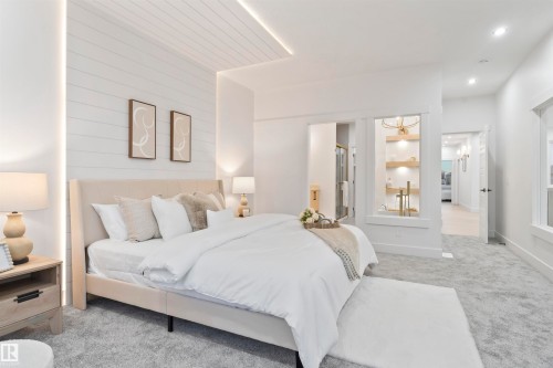 Expansive bedroom featuring light grey carpet, white shiplap accent wall, recessed lighting, and a built-in display niche with wooden shelving - 3305 Chickadee Drive, Edmonton, AB 
