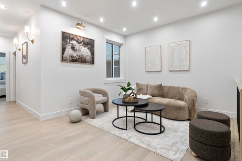 Living area with light wood-finish flooring, recessed lighting, and a window providing natural light - 3305 Chickadee Drive, Edmonton, AB 
