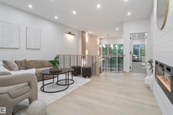 Open-concept living space with light wood-finish flooring - 