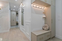 Integrated entryway storage featuring a built-in bench, two drawers, and overhead cabinetry - 