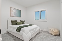 Light-filled room featuring a large window with white trim, plush gray carpeting, and crisp white walls - 