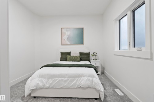 Bedroom featuring light gray carpeting, crisp white walls, and a window with white trim - 3305 Chickadee Drive, Edmonton, AB 