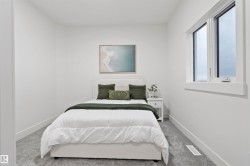 Bedroom featuring light gray carpeting, crisp white walls, and a window with white trim - 