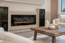 Built-in linear electric fireplace with a black glass front - 