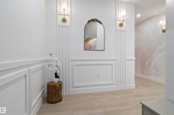 Entryway featuring decorative wainscoting and vertical wall paneling - 