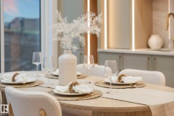 Light-toned dining table with a textured runner, complemented by cream chairs - 
