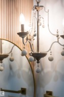 Ornate chandelier featuring a candelabra-style bulb and decorative spherical accents - 