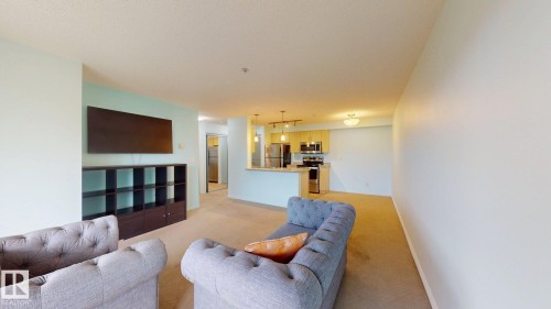 Open-concept living area featuring light-toned carpeting and neutral wall colors - 209 13908 136, Edmonton, AB 