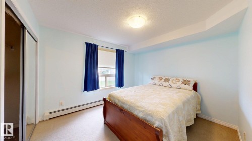 Light blue walls complementing neutral carpeting - 209 13908 136, Edmonton, AB 