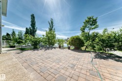 Expansive outdoor patio featuring paver stones with a varied pattern - 
