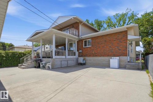 Expansive concrete driveway leading to a covered patio - 12131 101 Street Nw, Edmonton, AB 