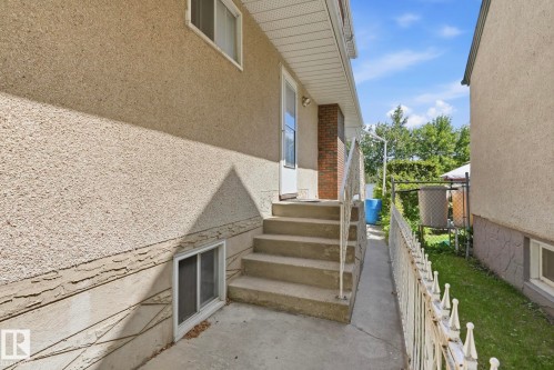 Stucco exterior with concrete steps leading to an entry door - 12131 101 Street Nw, Edmonton, AB 