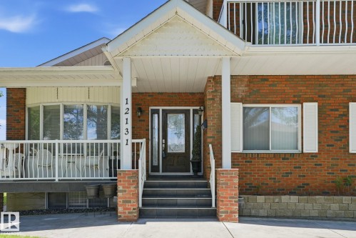 Brick facade with white trim, featuring a covered entry with steps - 12131 101 Street Nw, Edmonton, AB 