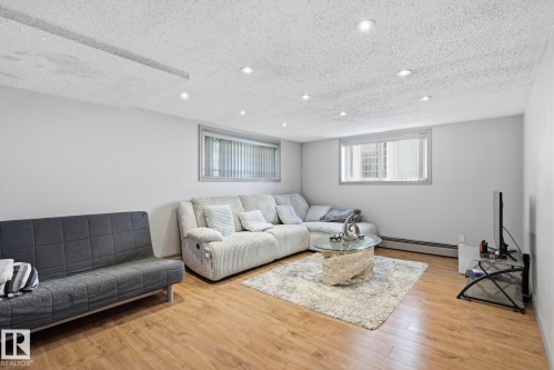 Spacious room featuring wood-finish flooring, recessed lighting, and light-toned walls - 12131 101 Street Nw, Edmonton, AB 