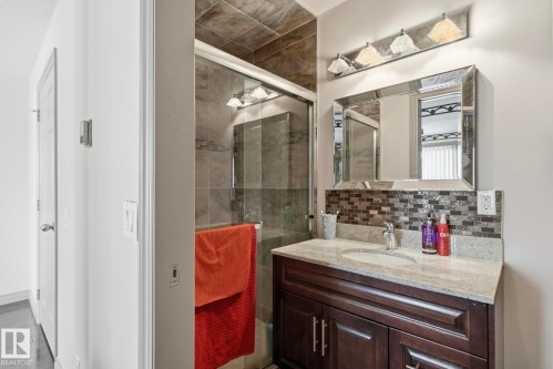 Bathroom vanity with granite countertop and integrated sink - 12131 101 Street Nw, Edmonton, AB 