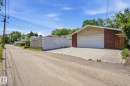 Detached two-car garage with a concrete driveway and an automatic overhead door - 12131 101 Street Nw, Edmonton, AB 