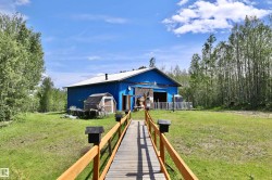 Expansive blue outbuilding with a white roof - 