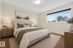 Recessed lighting illuminates this room featuring a large window with gridded panes, wood-finish baseboards, and neutral wall tones - 