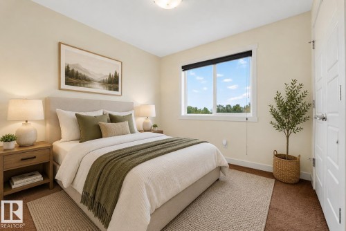 Inviting bedroom featuring neutral wall tones, a large window with ample natural light, a textured area rug, and a solid white door with paneling - 5244 1A Avenue, Edmonton, AB 