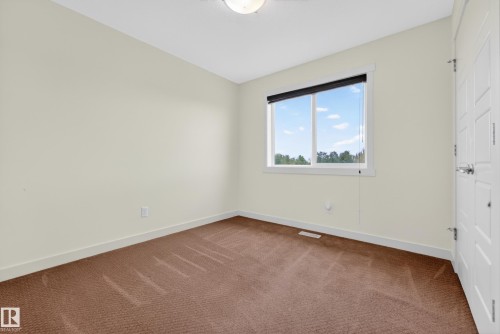 Neutral-toned walls complement the brown carpeted flooring - 5244 1A Avenue, Edmonton, AB 