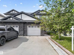 Contemporary exterior with stone veneer and horizontal siding accents - 