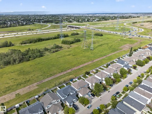 Aerial perspective showcasing a residential street with multiple single-family homes, each featuring individual rear yards - 5244 1A Avenue, Edmonton, AB 