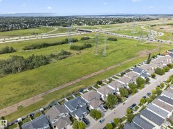 Aerial perspective showcasing a residential street with multiple single-family homes, each featuring individual rear yards - 