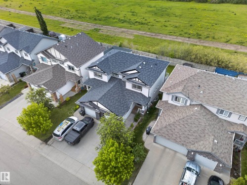 White siding exterior with dark asphalt shingle roofing - 5244 1A Avenue, Edmonton, AB 