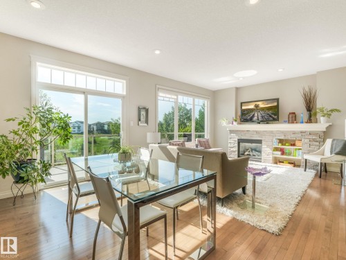 Open-concept living space with wood-finish flooring - 3 1641 James Mowatt Trail, Edmonton, AB 
