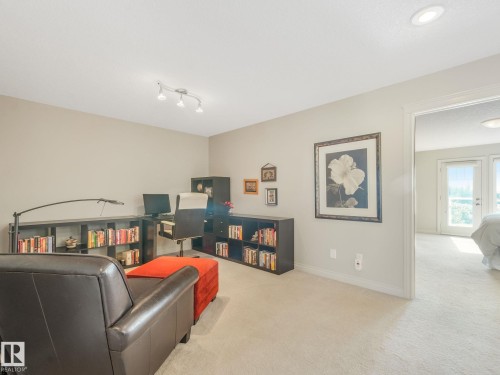 Versatile bonus room featuring recessed lighting and neutral wall tones - 3 1641 James Mowatt Trail, Edmonton, AB 
