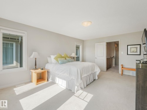 Carpeted room with neutral wall paint and two windows - 3 1641 James Mowatt Trail, Edmonton, AB 