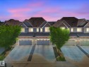 Modern townhomes featuring multi-tone siding, stone accents, and pitched roofs - 3 1641 James Mowatt Trail, Edmonton, AB 