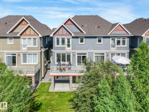Two-story exterior with a ground-level patio and an upper-level deck - 3 1641 James Mowatt Trail, Edmonton, AB 