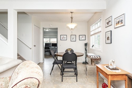 Well-lit interior featuring a dropped ceiling beam and a light fixture with a frosted glass shade - 18 Walden Park, St. Albert, AB 