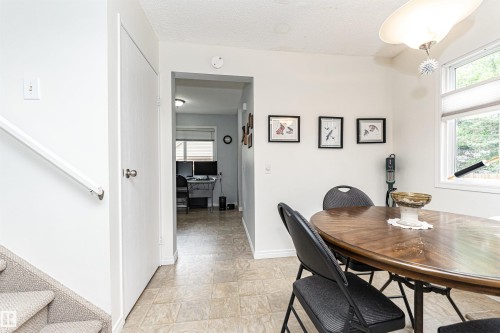 Dining space featuring a window, overhead lighting fixture, and tile flooring - 18 Walden Park, St. Albert, AB 