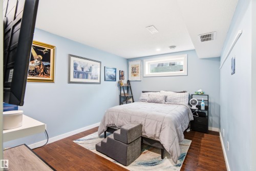 Bedroom featuring recessed lighting, light blue walls, and wood-finish flooring - 21384 88 Avenue, Edmonton, AB 