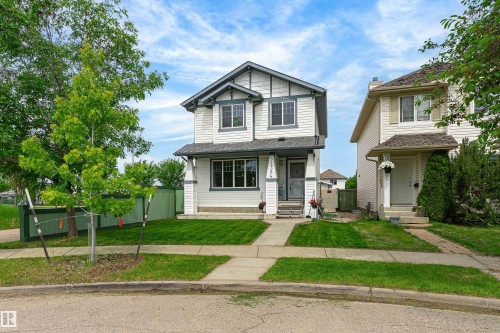 Two-story residence featuring white siding and dark trim accents - 21384 88 Avenue, Edmonton, AB 