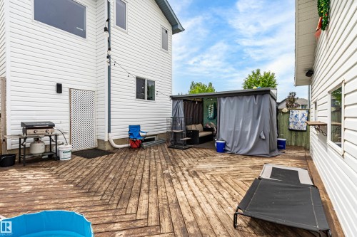 Expansive outdoor deck featuring wood-finish flooring and a covered private patio area - 21384 88 Avenue, Edmonton, AB 