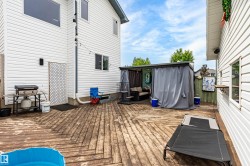 Expansive outdoor deck featuring wood-finish flooring and a covered private patio area - 