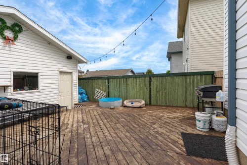Spacious wood-finish deck with a privacy fence and string lighting - 21384 88 Avenue, Edmonton, AB 