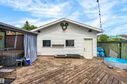 Expansive outdoor deck featuring wood-finish flooring, white vinyl siding, a dedicated side door, and a covered structure with draping - 