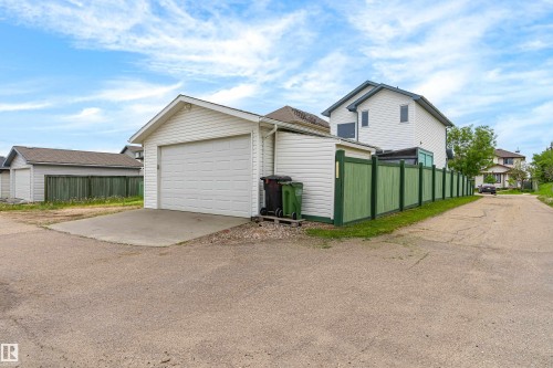 Detached garage with white siding and a concrete driveway - 21384 88 Avenue, Edmonton, AB 
