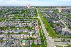 Aerial overview of a residential neighborhood with numerous single-family homes - 