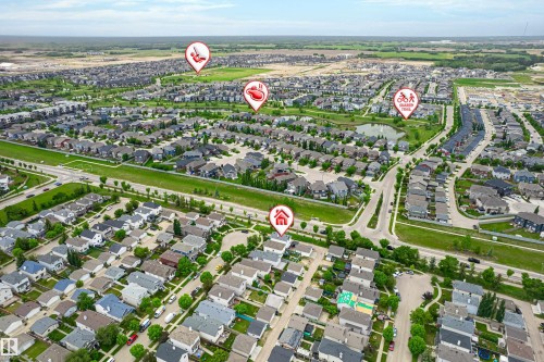 Expansive aerial view of a residential development featuring numerous single-family homes and townhomes - 21384 88 Avenue, Edmonton, AB 