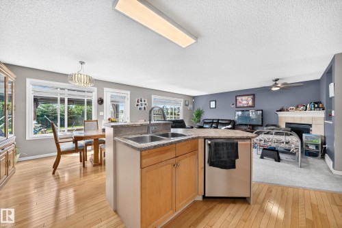 Kitchen island with double basin sink and stainless steel dishwasher - 3224 26 Street, Edmonton, AB 