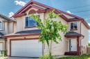 Two-story residence featuring light-toned siding and a burgundy trim accent - 3224 26 Street, Edmonton, AB 
